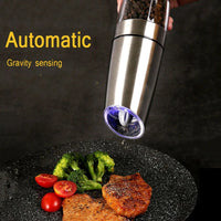 Automatic Grinder pouring spices on a plate of steak and some vegetables